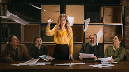 Image showing Young colleagues working together in a office styled like classical artworks. Look busy, attented, cheerful, successful. Concept of business, office, finance.