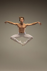 Image showing Young and graceful ballet dancer isolated on studio background. Art, motion, action, flexibility, inspiration concept.