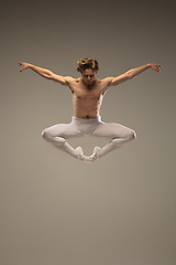 Image showing Young and graceful ballet dancer isolated on studio background. Art, motion, action, flexibility, inspiration concept.