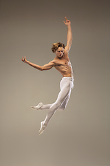 Image showing Young and graceful ballet dancer isolated on studio background. Art, motion, action, flexibility, inspiration concept.