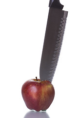 Image showing Knife cutting an apple