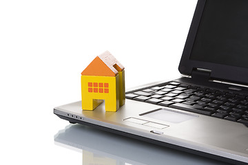 Image showing House toy over a laptop