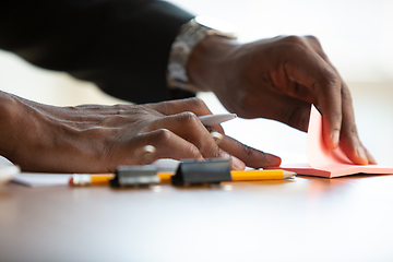 Image showing African-american entrepreneur, businessman working concentrated in office