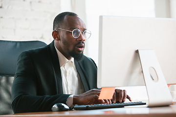 Image showing African-american entrepreneur, businessman working concentrated in office