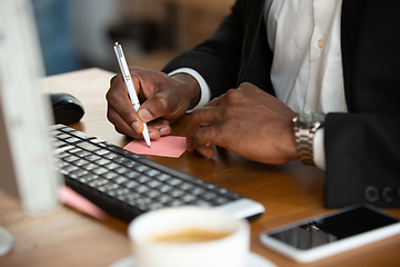 Image showing African-american entrepreneur, businessman working concentrated in office