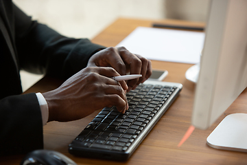 Image showing African-american entrepreneur, businessman working concentrated in office