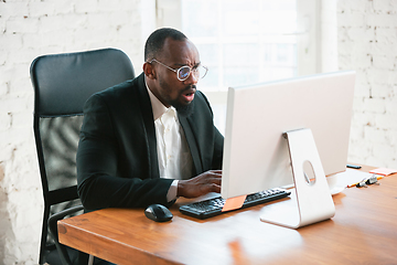 Image showing African-american entrepreneur, businessman working concentrated in office