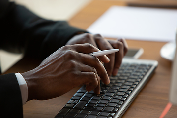 Image showing African-american entrepreneur, businessman working concentrated in office