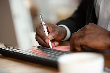 Image showing African-american entrepreneur, businessman working concentrated in office