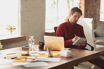 Image showing Caucasian entrepreneur, businessman, manager trying to work, looks funny, lazy and spending time