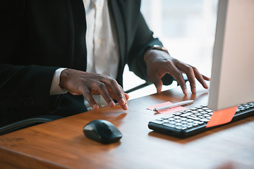 Image showing African-american entrepreneur, businessman working concentrated in office