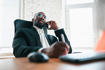 Image showing African-american entrepreneur, businessman working concentrated in office