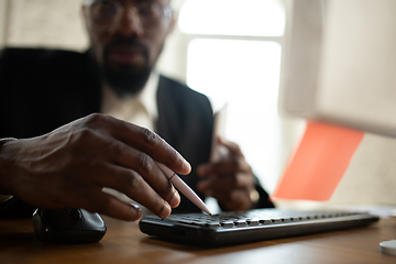 Image showing African-american entrepreneur, businessman working concentrated in office