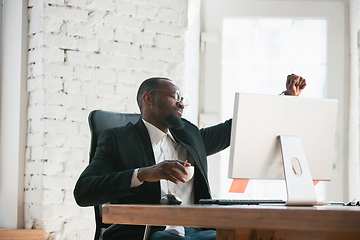 Image showing African-american entrepreneur, businessman working concentrated in office