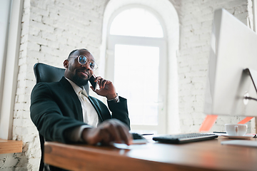 Image showing African-american entrepreneur, businessman working concentrated in office