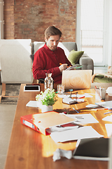 Image showing Caucasian entrepreneur, businessman, manager trying to work, looks funny, lazy and spending time