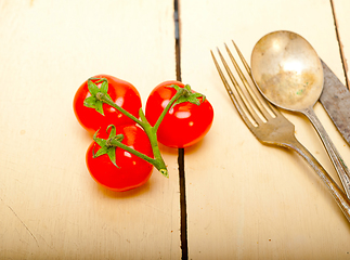 Image showing ripe cherry tomatoes over white wood