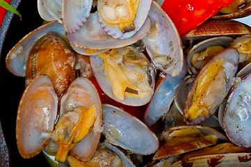 Image showing fresh clams on an iron skillet