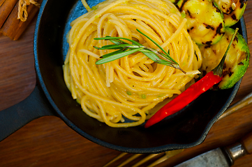 Image showing italian spaghetti pasta with zucchini sauce on iron skillet