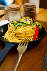 Image showing italian spaghetti pasta with zucchini sauce on iron skillet