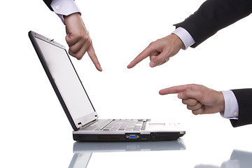 Image showing Three hands pointing to a laptop