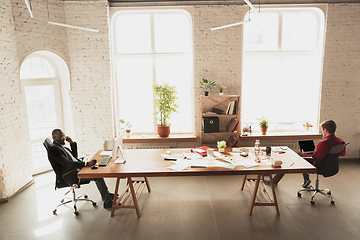 Image showing Caucasian entrepreneur, businessman, manager trying to work, looks funny, lazy and spending time