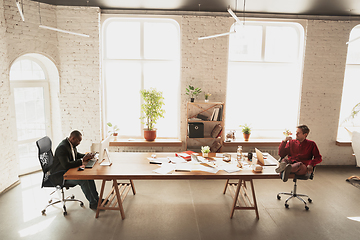 Image showing Caucasian entrepreneur, businessman, manager trying to work, looks funny, lazy and spending time