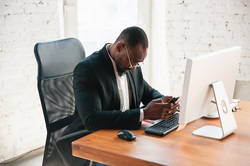 Image showing African-american entrepreneur, businessman working concentrated in office