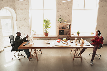 Image showing Caucasian entrepreneur, businessman, manager trying to work, looks funny, lazy and spending time