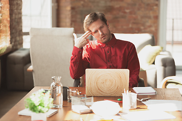 Image showing Caucasian entrepreneur, businessman, manager trying to work, looks funny, lazy and spending time