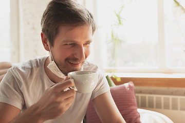 Image showing Young man studying at home during online courses for financist, economist, managers