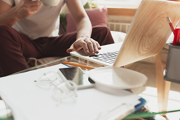 Image showing Young man studying at home during online courses for financist, economist, managers