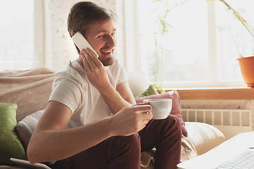 Image showing Young man studying at home during online courses for marketer, architect, translator