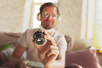 Image showing Young man studying at home during online courses for photographer, studio assistant