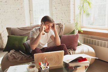 Image showing Young man studying at home during online courses for designers, SMM, SEO, analytics