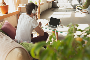 Image showing Young man studying at home during online courses for retailer, buyer, teacher