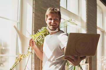 Image showing Young man studying at home during online courses for gardener, biologist, florist