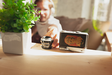 Image showing Young man studying at home during online courses for photographer, studio assistant