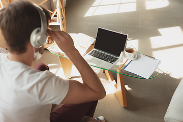 Image showing Young man studying at home during online courses for retailer, buyer, teacher