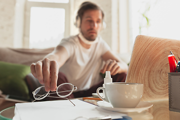 Image showing Young man studying at home during online courses for programmer, bug-tester, consulter