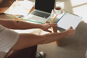 Image showing Young man studying at home during online courses for retailer, buyer, teacher