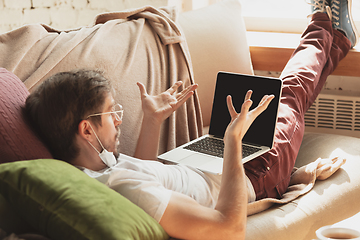 Image showing Young man studying at home during online courses for journalist, critics, writers