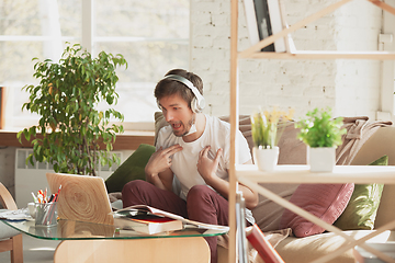 Image showing Young man studying at home during online courses for marketer, architect, translator