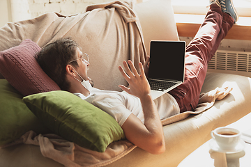 Image showing Young man studying at home during online courses for journalist, critics, writers