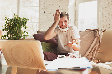 Image showing Young man studying at home during online courses for musician, drummer, producer