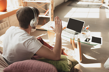 Image showing Young man studying at home during online courses for musician, drummer, producer