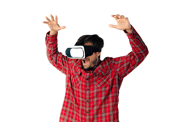 Image showing Man emotional playing, using virtual reality headset isolated on white studio background