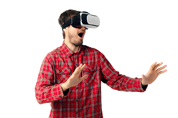 Image showing Man emotional playing, using virtual reality headset isolated on white studio background