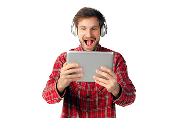 Image showing Man using tablet and headphones isolated on white studio background