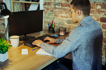 Image showing Man working from home during coronavirus or COVID-19 quarantine, remote office concept